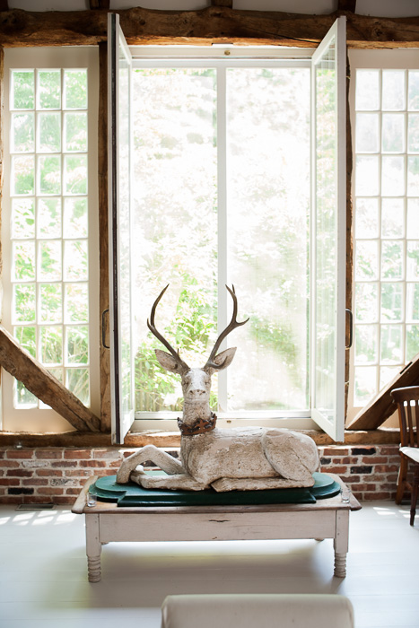 A near life-sized wooden sculpture of a deer at Two Barns, the home of Literary Agent Ed Victor. Bridgehampton, NY