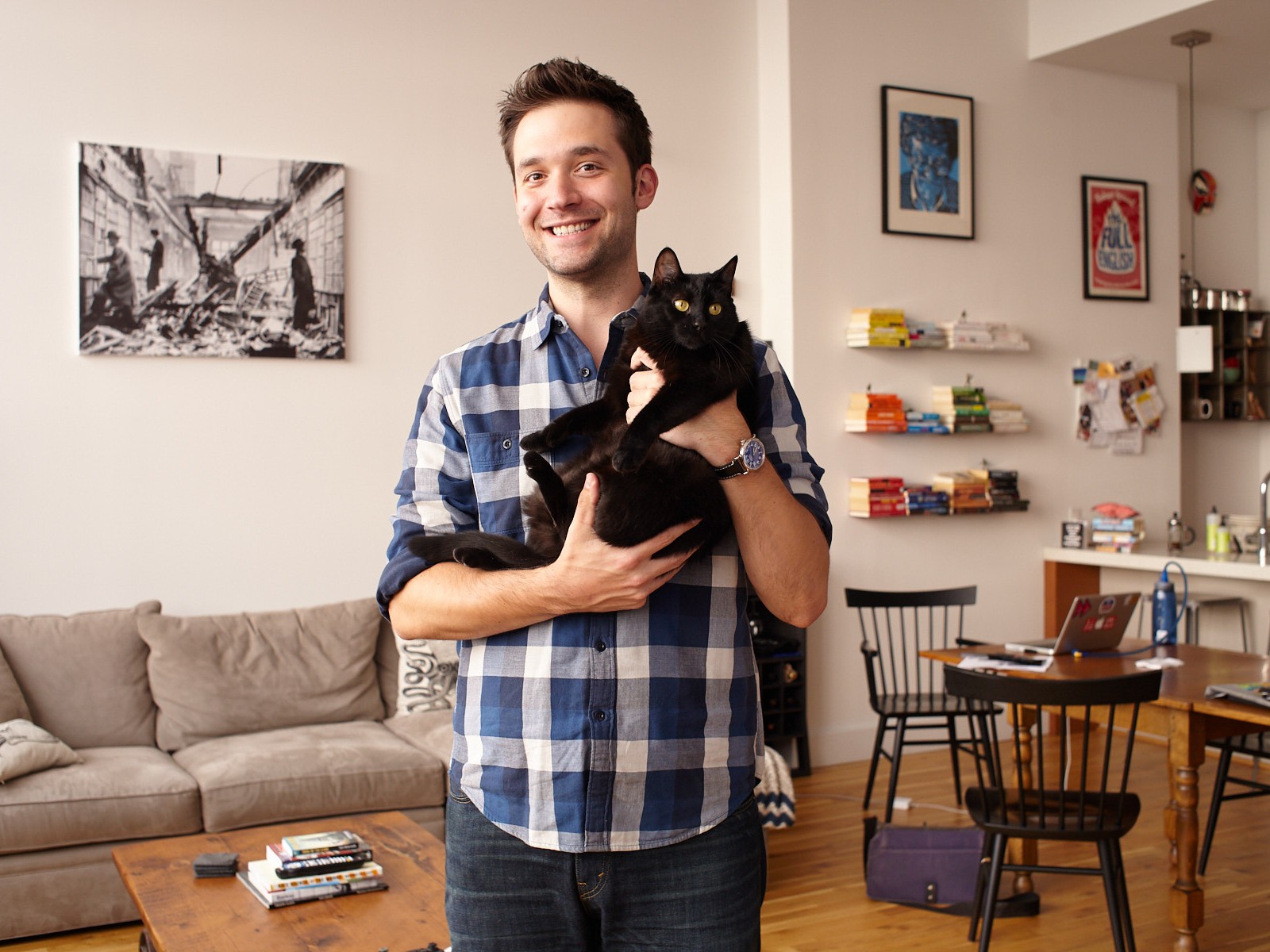 Portraits of Reddit co-founder Alexis Ohanian in Brooklyn NYC apartment holding his kat Karma