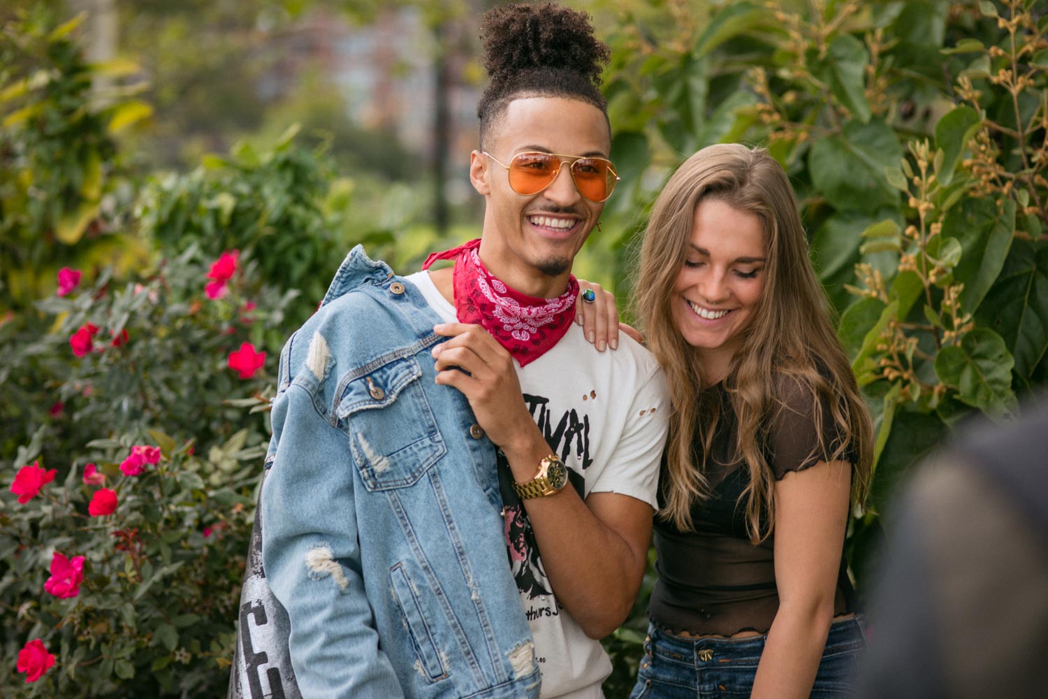 Lifestyle photography of cute young couple laughing and talking at NYC park