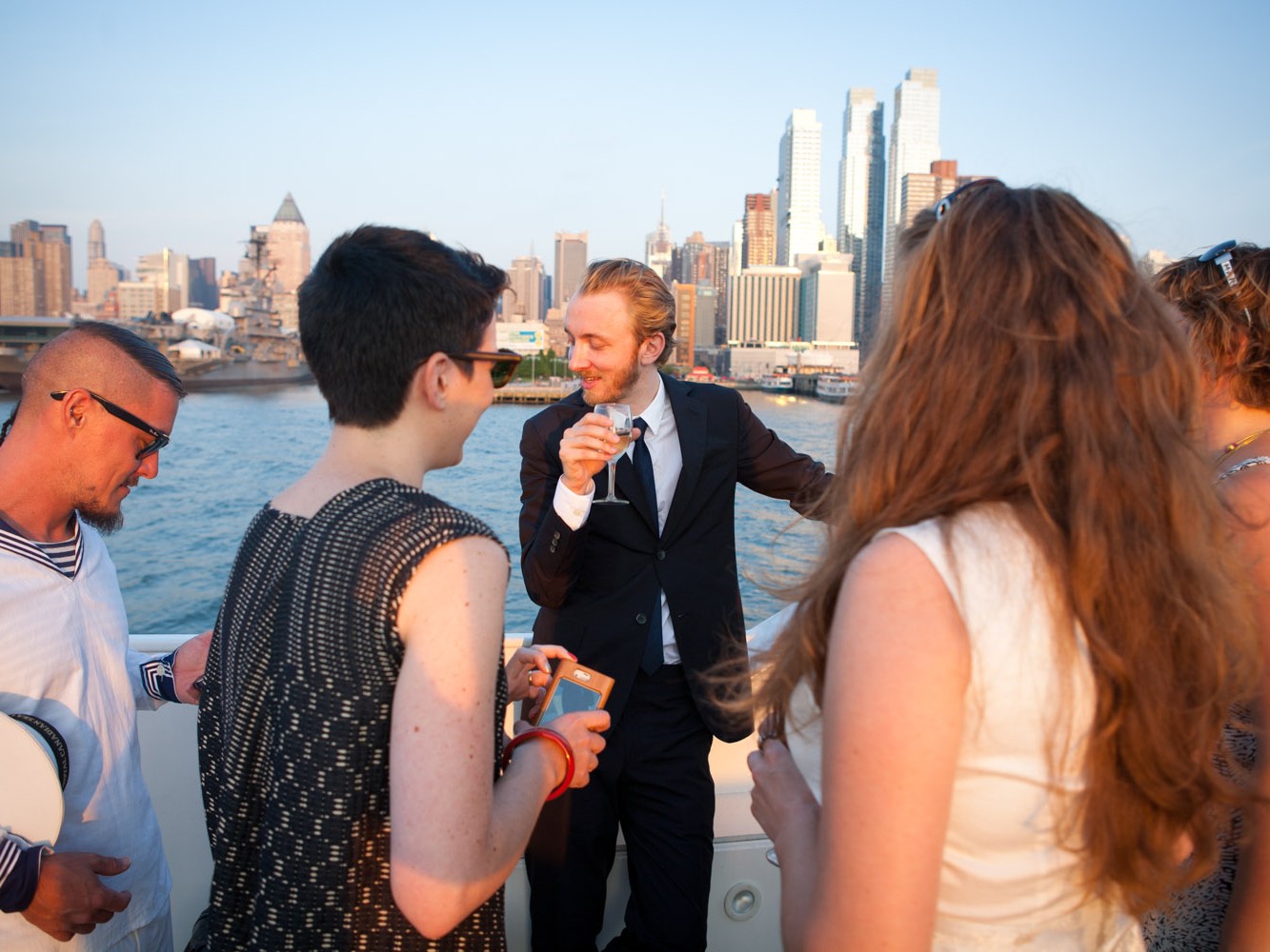 Gay couple have upscale wedding on yacht sailing around Hudson River NYC.