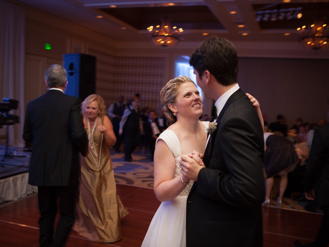 Stylish modern wedding ceremony held at posh, high-end, luxurious Four Seasons Hotel in downtown Philadelphia. Bride and groom have their first dance during wedding celebration.