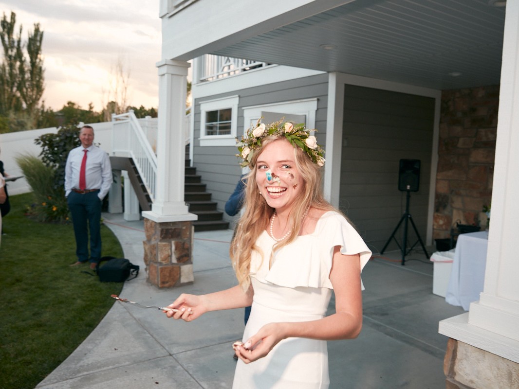 Young LDS bride with wedding cake on face after being married in a Mormon temple Utah