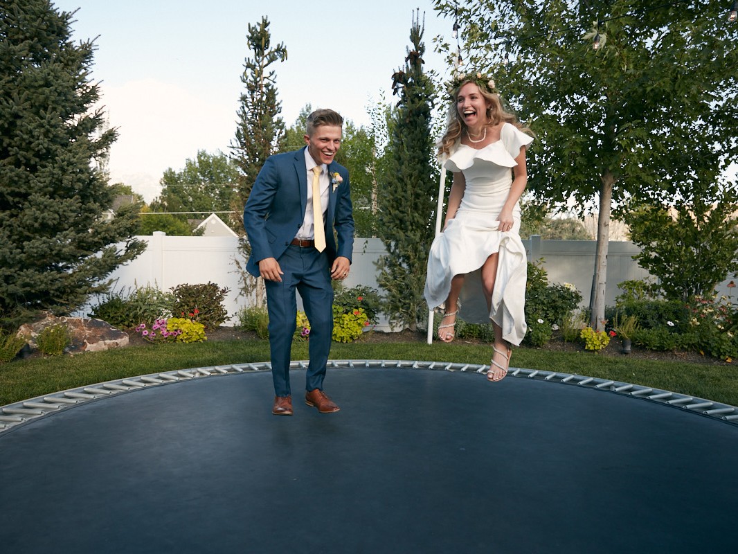 Young LDS couple jump on trampoline after being married in a Mormon temple Utah
