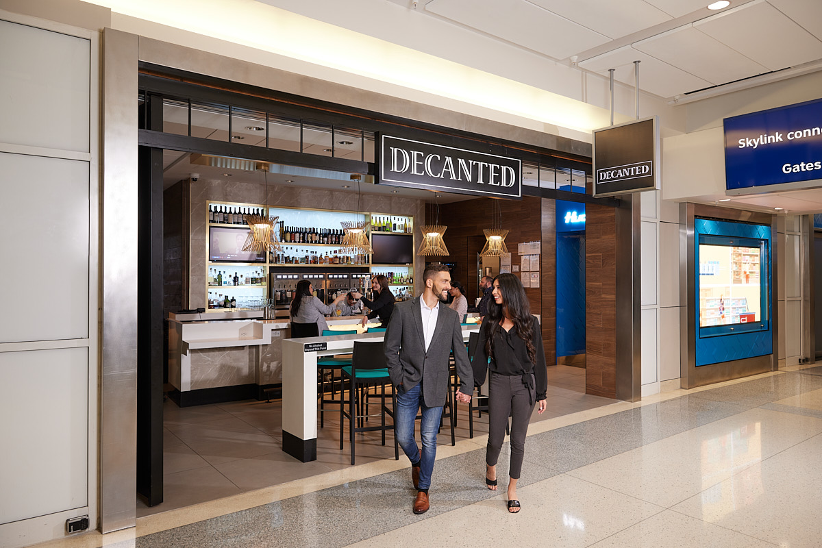 Dallas Lifestyle Photographer | Couple Walking Out of DFW Airport Wine Bar