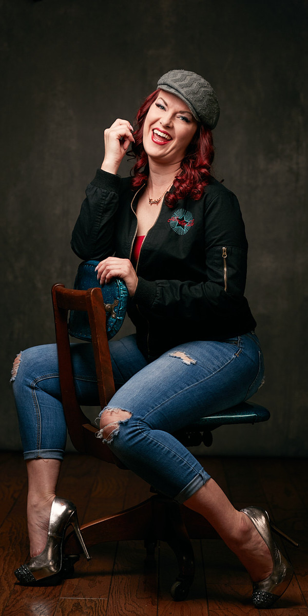 Dallas Portrait Photographer - Casual portrait of happy woman laughing on designer chair