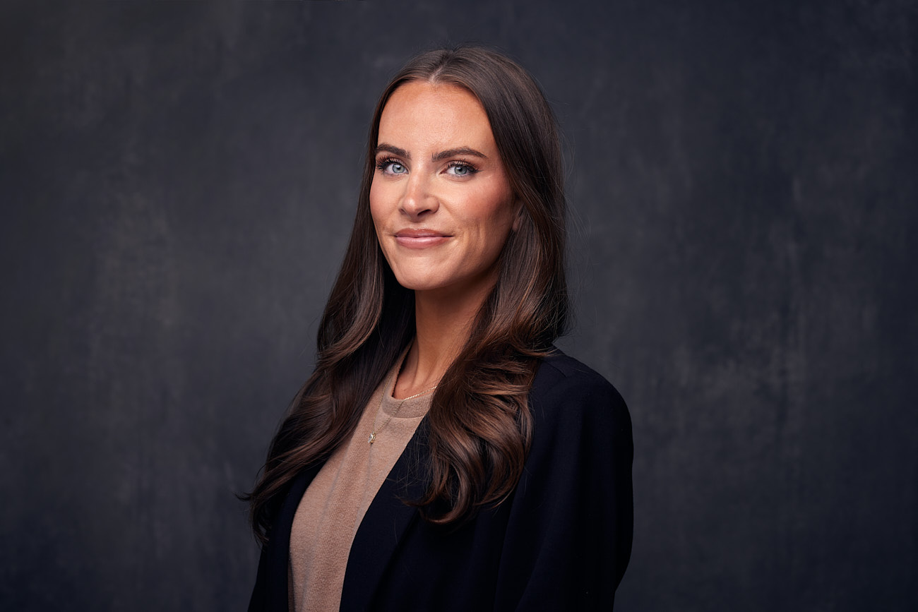 The Benefits of Regularly Refreshing Corporate Headshots - Businesswoman Headshots Against Textured Backrop